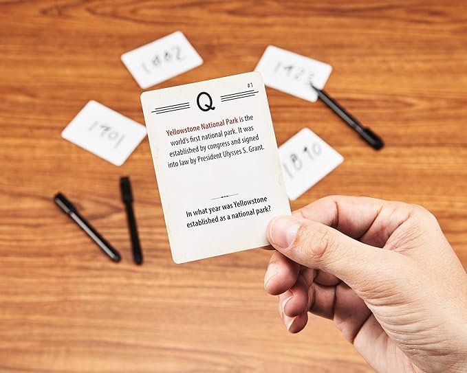 Board game titled 'Trekking the National Parks Trivia' with cards, board, and markers displayed.